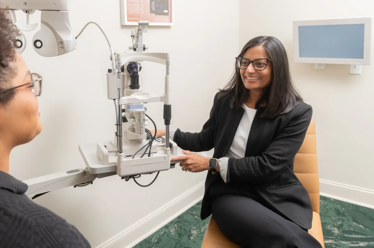 Dr. Mital Patel with a patient at the slit lamp in an East Cobb exam room